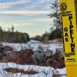 Yellow pole natural gas pipeline marker in Otisfield, Maine