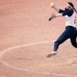A pitcher for the University of Southern Maine softball team goes through her windup motion during a game.