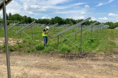 Worker inspects the construction of a community solar farm