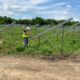 Worker inspects the construction of a community solar farm