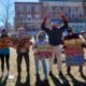 Seven college students hold signs protesting against climate change and demanding the University of Maine System divest fossil fuels from its endowment