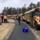 School buses line up outside of a school
