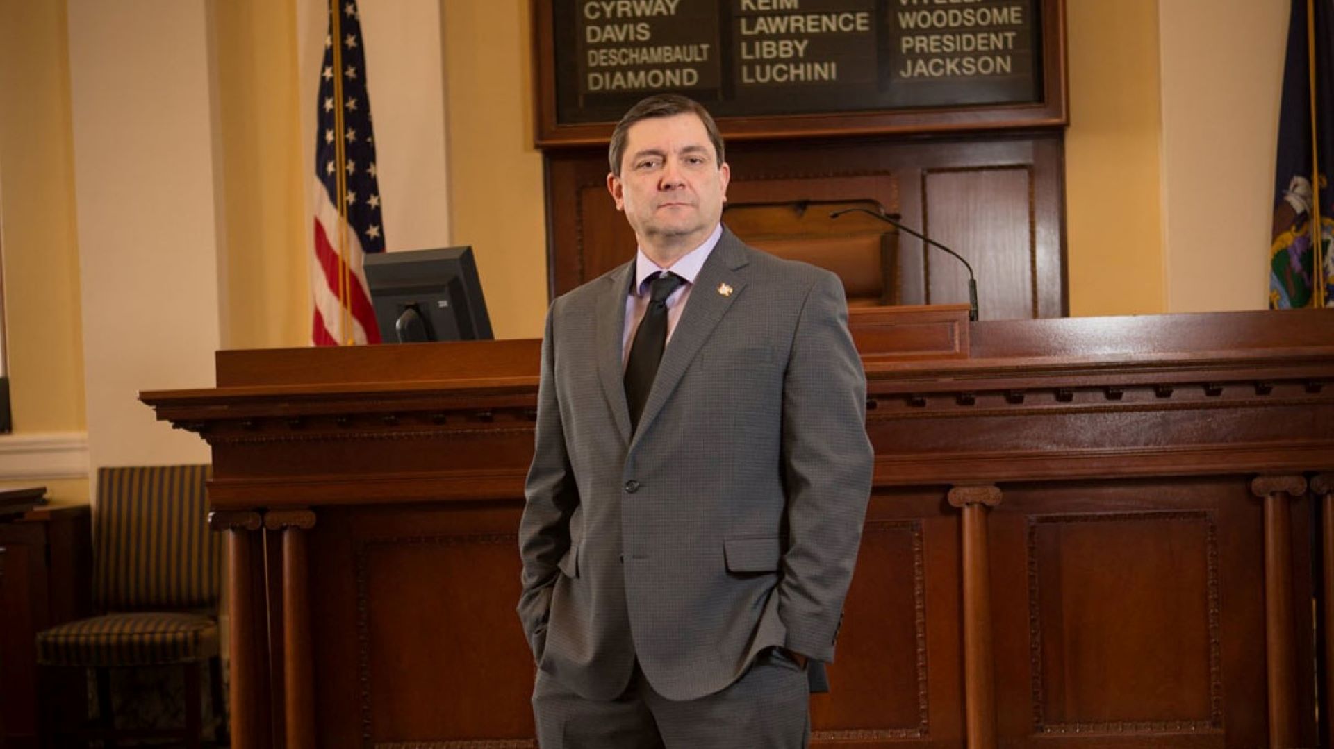 Troy Jackson poses for a photo within the senate chamber