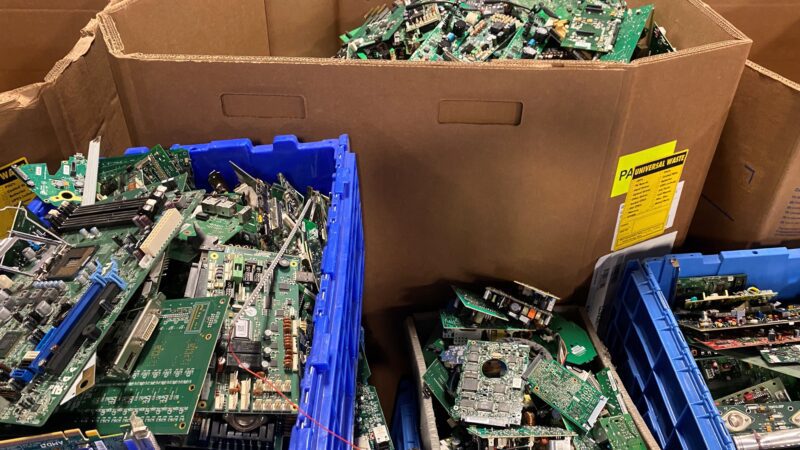 A box of discarded electronic devices collected by a technological recycling company