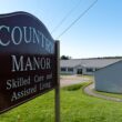 The exterior, including its sign, of Country Manor, which advertised skilled care and assisted living.