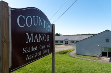 The exterior, including its sign, of Country Manor, which advertised skilled care and assisted living.