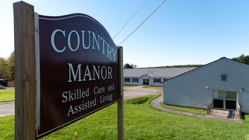 The exterior, including its sign, of Country Manor, which advertised skilled care and assisted living.