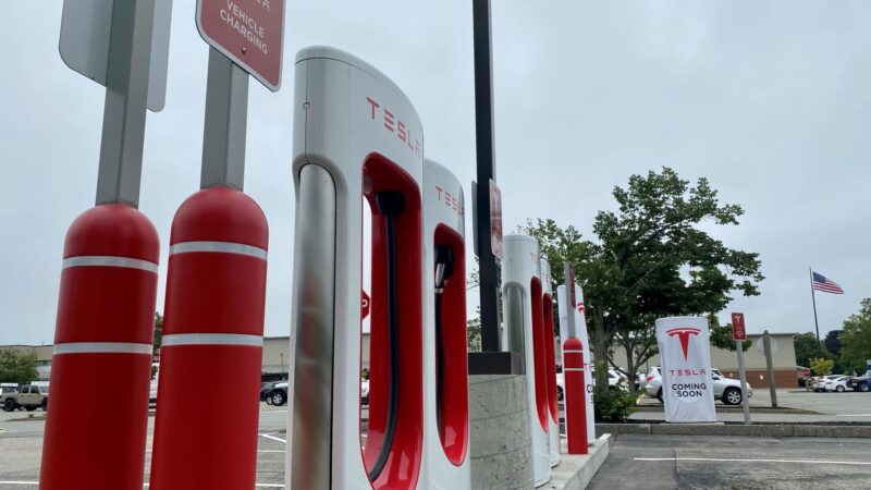 a row of tesla charging stations in a parking lot