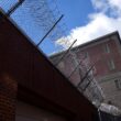 Exterior of the Androscoggin County Jail, including barbed wire at the top of a wall