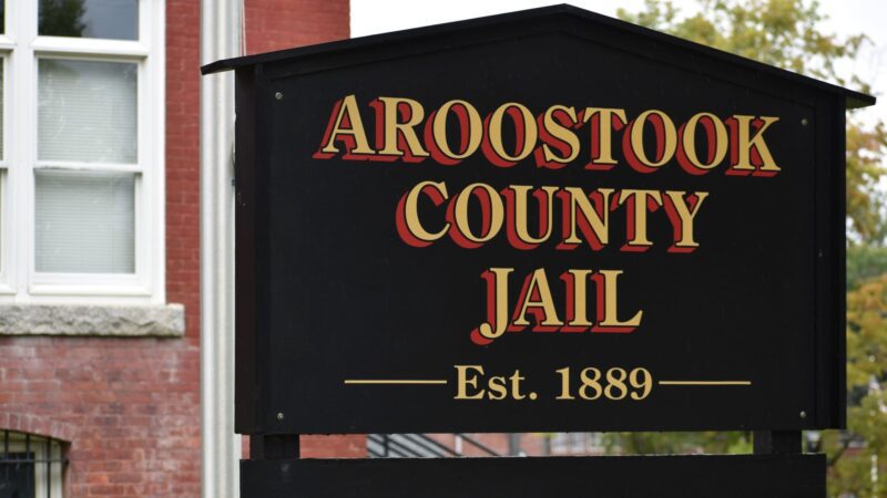 A sign for the Aroostook County Jail. The sign reads Aroostook County Jail, established 1889