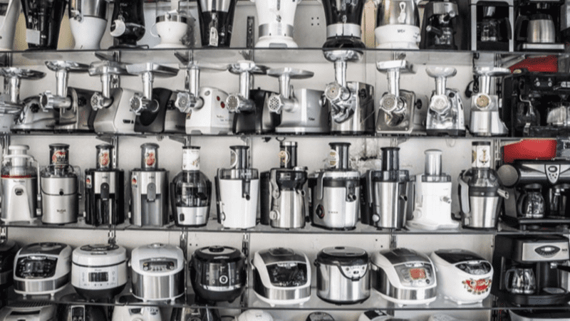 Several shelves filled with kitchen appliances such as blenders and air fryers