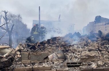 First responders attempt to search the rubble of a building that was attacked during Russia's invasion of Ukraine