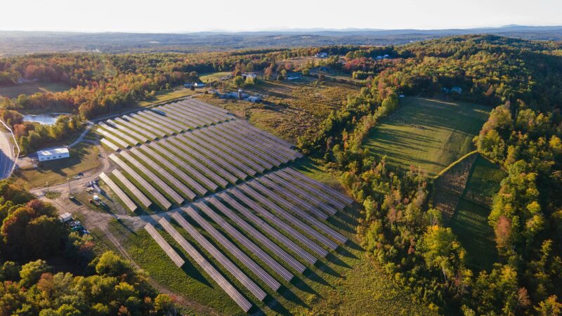 Solar power utility panels aerial view in Skowhegan Maine surrounded by trees
