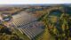 Solar power utility panels aerial view in Skowhegan Maine surrounded by trees