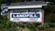 Sign at the entrance of the Juniper Ridge landfill. The sign reads Juniper Ride Landfill owned by State of Maine Operated By NewsMe, LLC