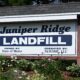 Sign at the entrance of the Juniper Ridge landfill. The sign reads Juniper Ride Landfill owned by State of Maine Operated By NewsMe, LLC