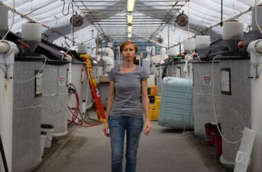 Sara Rademaker stands in her eel facility.