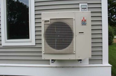 A heat pump attached to the outside of a building