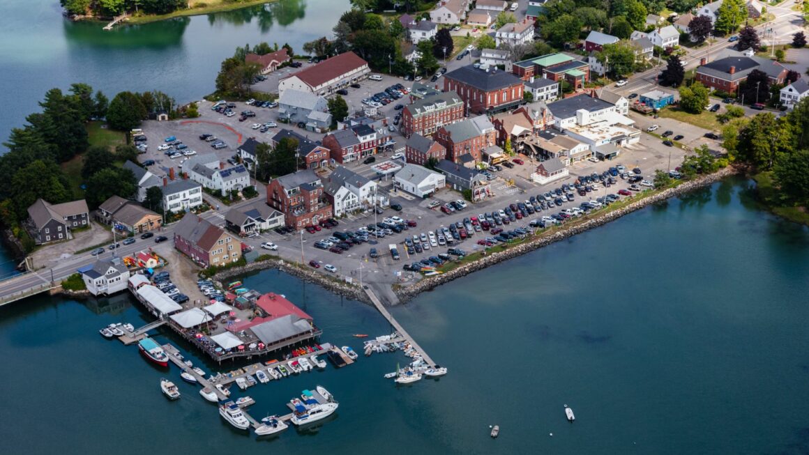 Aerial view of the body of water that surrounds parking lots in Damariscotta