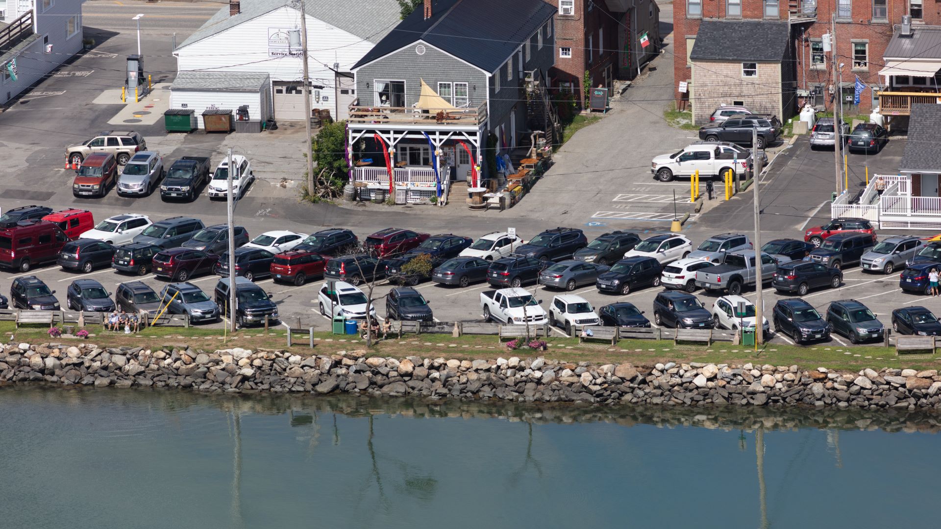 Aerial view of a body of water that surrounds a parking lot in Damariscotta
