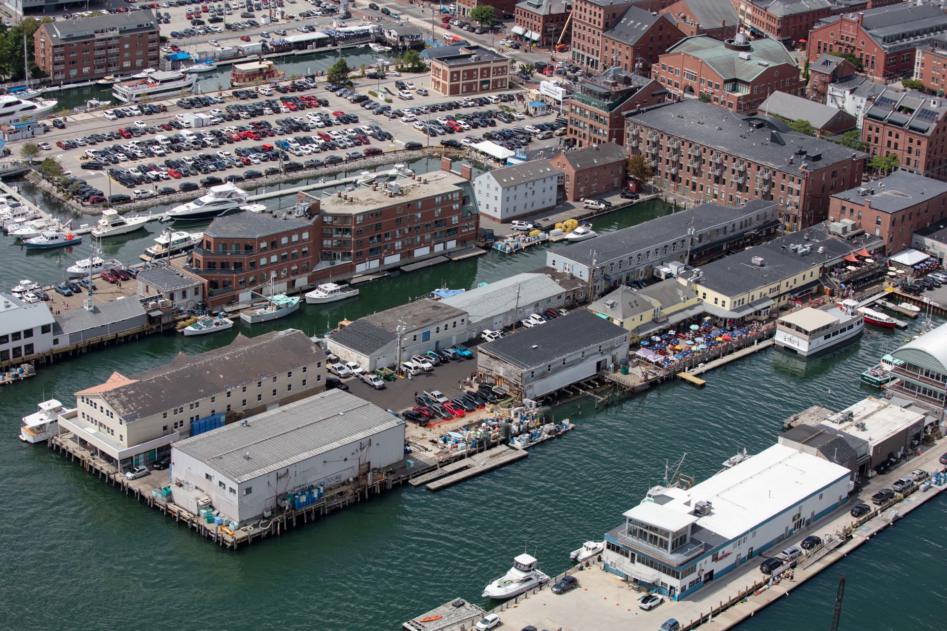 Close up aerial view of the businesses and parking lots surrounded by water in Portland