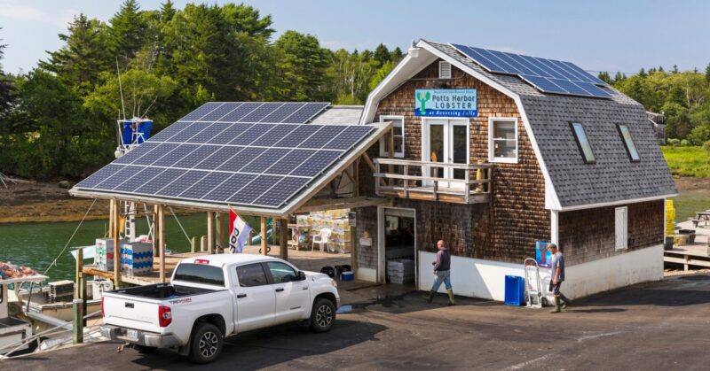 The exterior of Potts Lobster with solar panels lining the roof of the building.