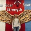 Rose Tuttle stands in front of the Sources of Strength eagle wings