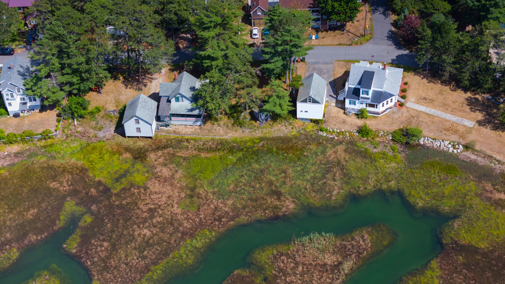 Aerial view of houses that sit alongside a marsh in Saco.
