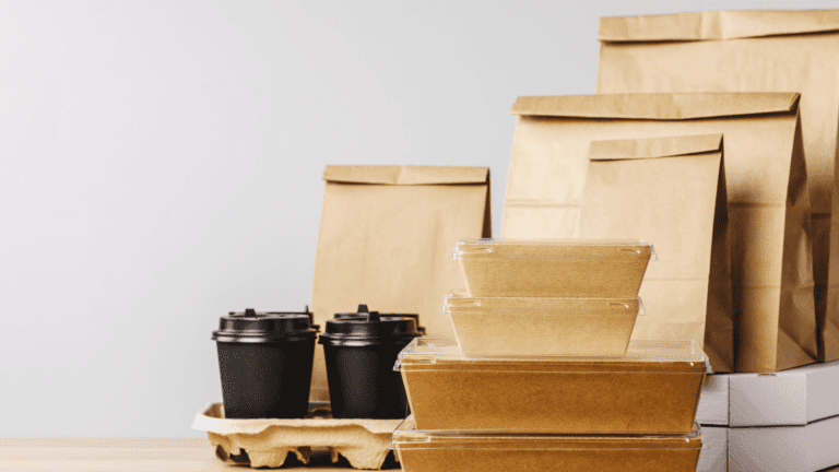 Several paper bags and takeout containers on a table