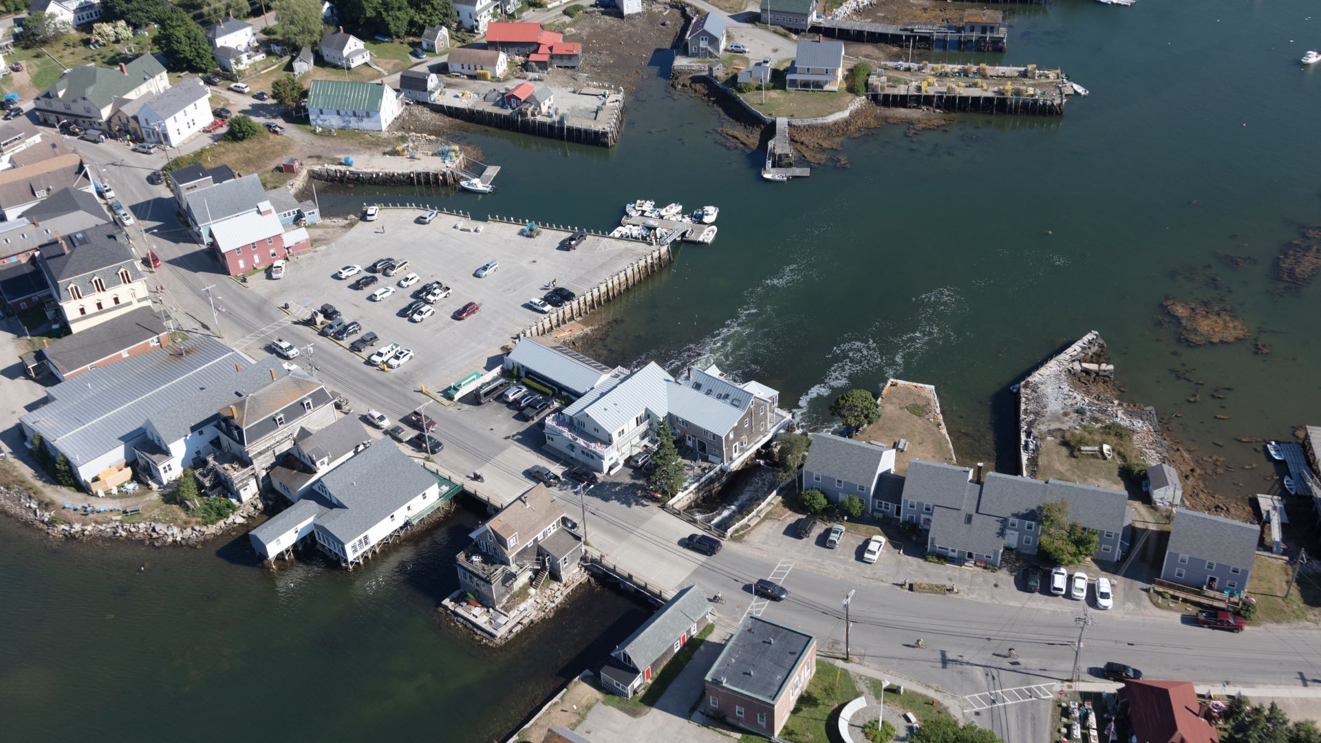 Aerial view of a parking lot and buildings on the edge of water in Vinalhaven