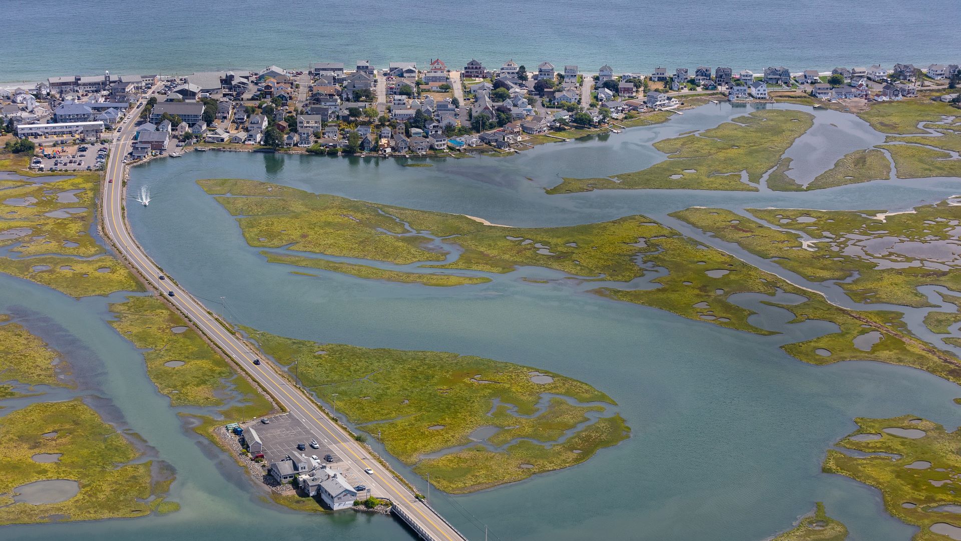 Aerial view of a causeway that is surrounded by a marsh.