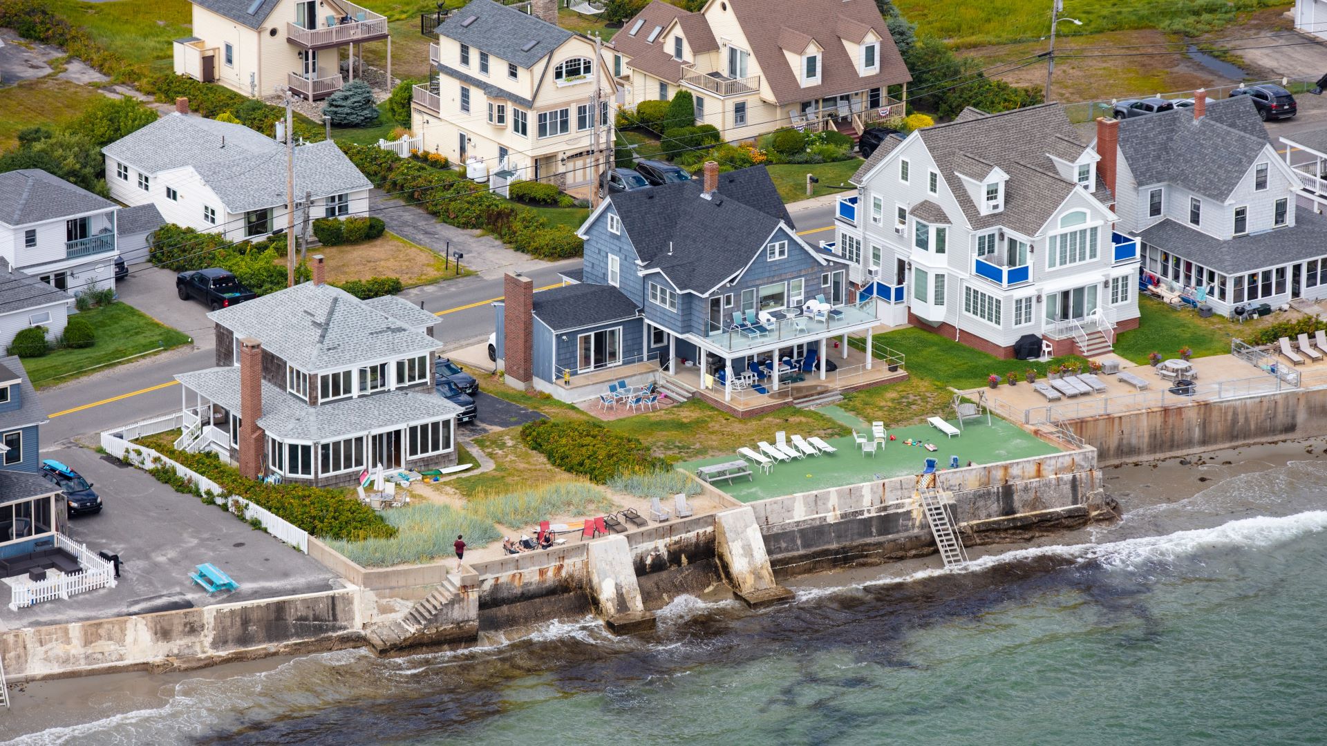 Aerial view of homes in Wells that are protected by seawall and their lawn