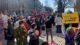 A crowd on a street in Portland rallies in support of the woman's decision to have an abortion. Many are holding signs, including one that reads bans off our bodies.