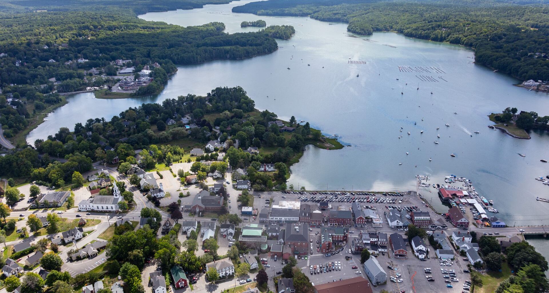 Aerial view of a parking lot in Damariscotta and homes that are at risk of being washed away