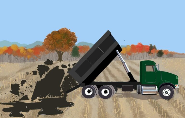 An illustration showing a green dump truck dumping black sludge in an empty field during the fall season. One of the clumps of sludge is in the shape of the state of Maine