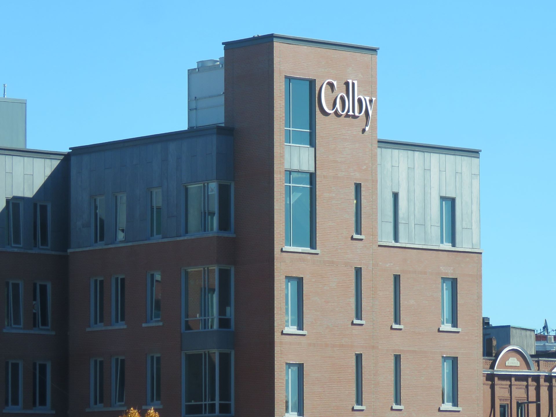 Exterior of a building that has the word Colby affixed towards the top of it