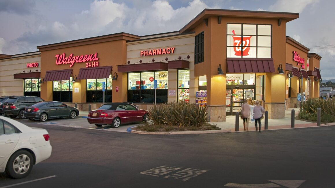 Exterior of a Walgreens location that touts the store features a pharmacy, photo center and is open 24 hours.