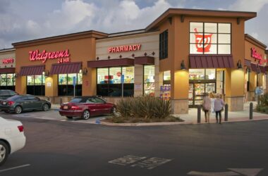 Exterior of a Walgreens location that touts the store features a pharmacy, photo center and is open 24 hours.