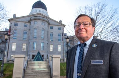 Jeff Evangelos stands in front of the State House