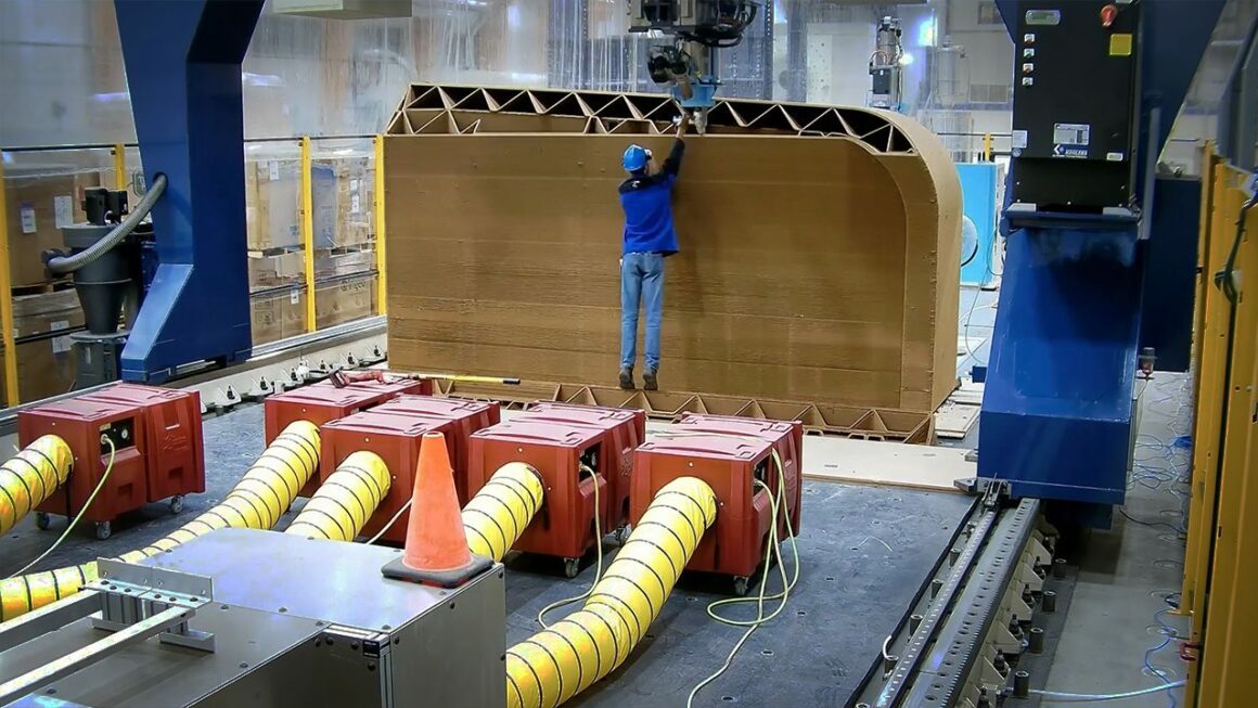 A man aligns the 3D printer.