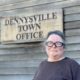 Violet Willis stands in front of a sign for the Dennysville Town Office.