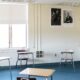 An empty classroom with four desks for students spread out for social distancing amid COVID-19