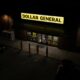 The exterior of a Dollar General store at night.