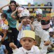 A classroom of Pre-K students dance to a song in a classroom.