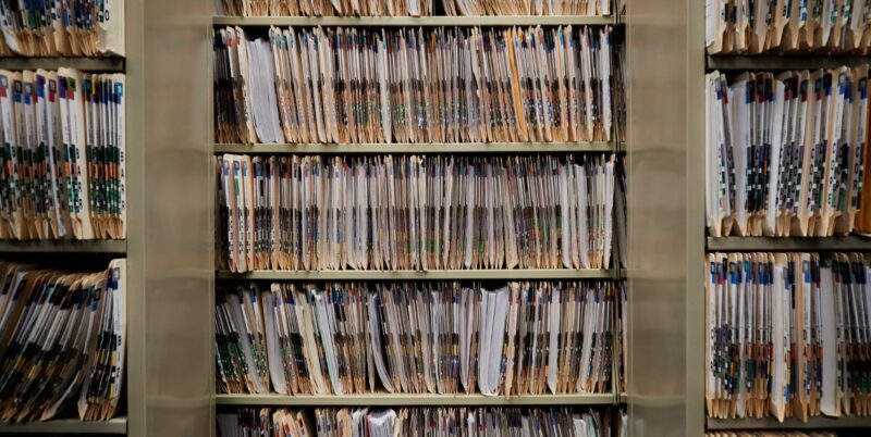 Numerous shelves packed with folders of court case files.