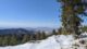 A snow covered mountain paired with green forest trees in Boise, Idaho.
