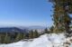 A snow covered mountain paired with green forest trees in Boise, Idaho.