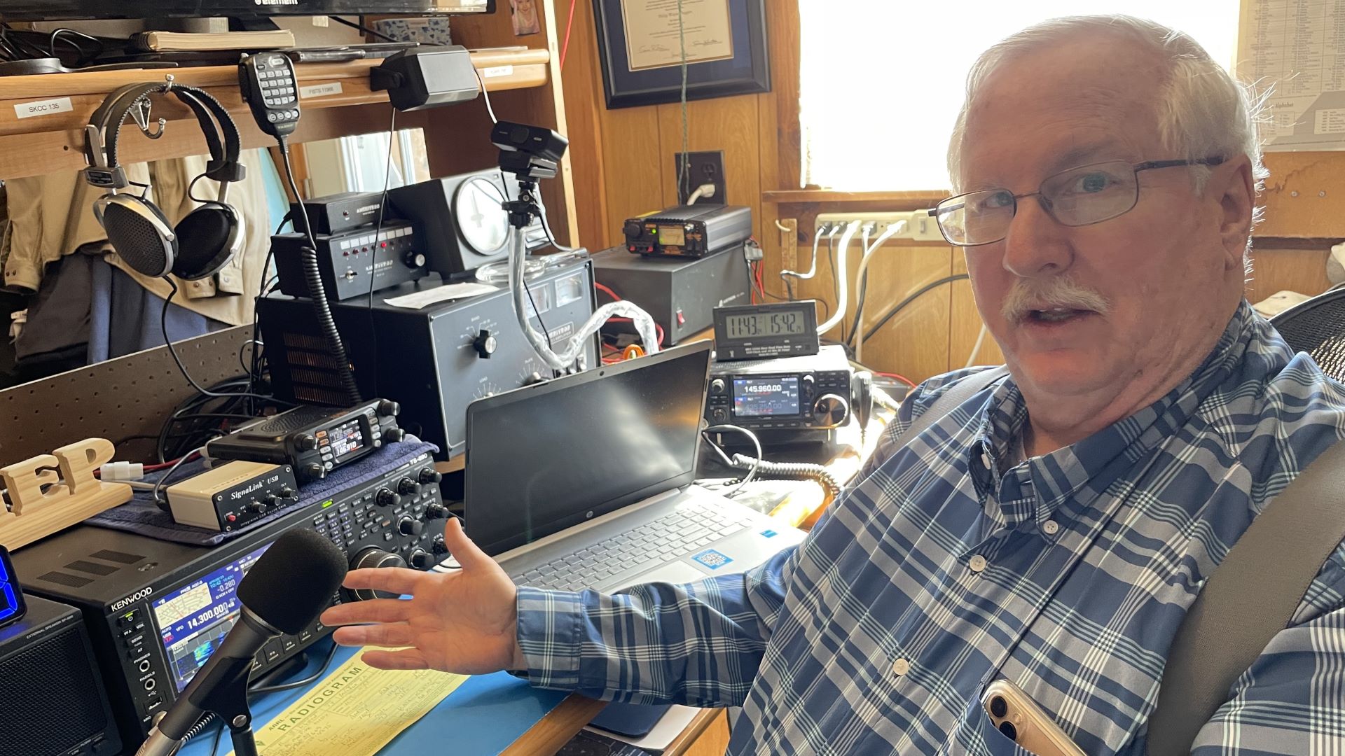 Phil Duggan shows off his ham radio control room. 