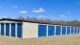 A self storage building with blue shutter doors. 