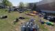 Tents, trash and a pile of propane tanks are seen around the grassy homeless campsite at Bayside.